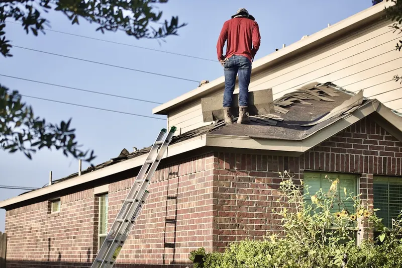 Professional roofer working on a residential roof in Black Point Beach Club
